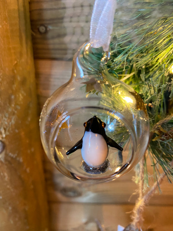 Glass and gold star bauble with penguin