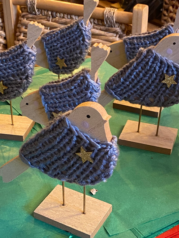 Wooden bird in blue knitted jumper